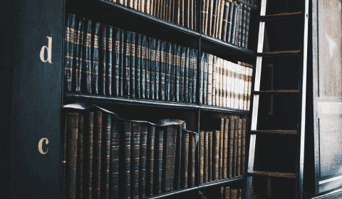 Books about mortgage law sitting on a black bookcase
